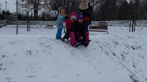 Kids eat snow after crashing on sled