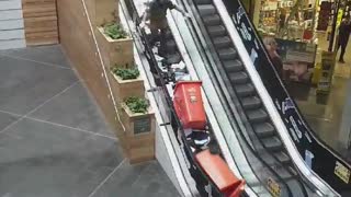 Man Makes a Huge Paper Mess Going Up Escalator