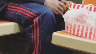 Man eating chicken on train throws bones on floor