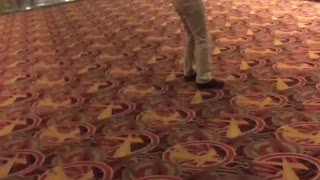 Guy black shirt khaki jeans backflip movie theater fail