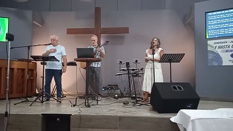 "By our love," sung by Marisol and Danny at the Calvary Center Church.