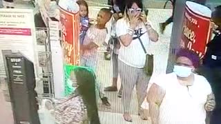 Woman using children to pickpocket a shopper