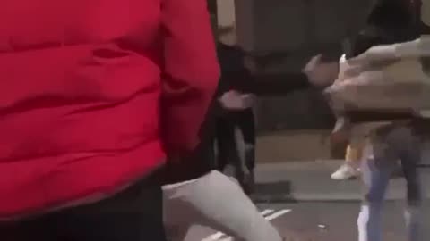 Man gets saved by flying kick in street fight