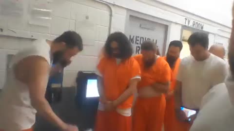 Jan6 prisoners say prayer and sing the National Anthem