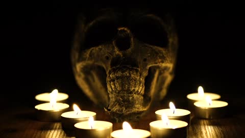 A Skull With Lighted Candles