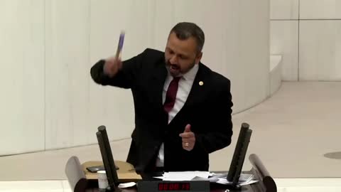 Turkish lawmaker smashes phone with hammer in parliament to protest social media bill