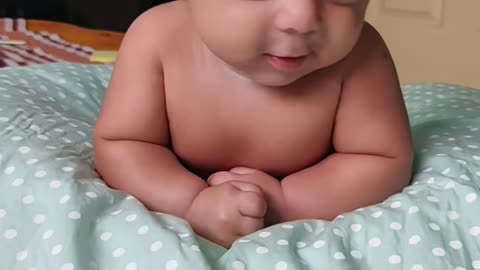 Cute baby enjoys tummy time