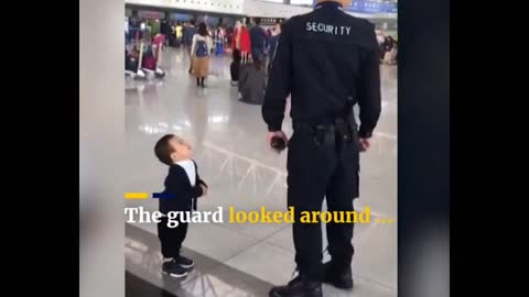 Cute boy wants a hug from security guard.