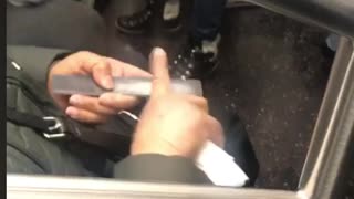 Woman files her index finger with nail filer on subway train