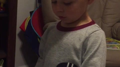 Smart And Cute Three Year Old Reading His Favorite Book