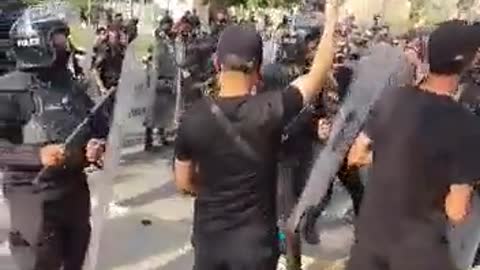 Riot police and security forces heavily deployed at the entrance gates of the Baghdad Green Zone