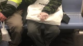 Woman brushes her teeth on subway