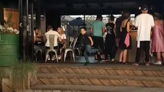 Little boy black shirt dancing by stairs