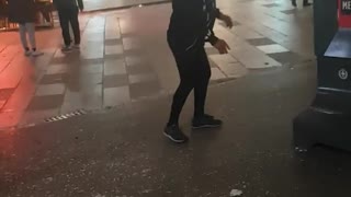 Woman balances plastic bag on her head and shares a cigarette
