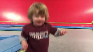 Little boy maroon trampoline fall