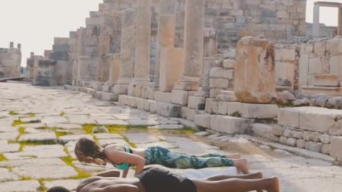 Man and Woman Doing Yoga at Ruins