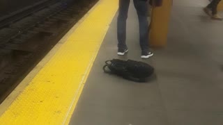 Old man cleaning yellow subway steel bar