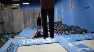 Trampoline flips into blonde friend