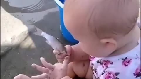 A cute girl playing with a fish