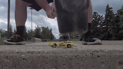 Man Breaks Toy Car And Concrete Stairs With Sledgehammer At The Same Time