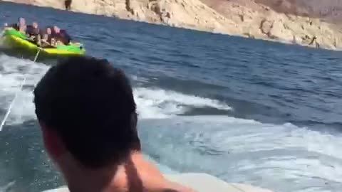 Girls on green tube on water girl falls