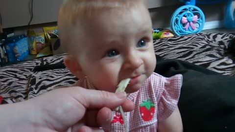 Cute baby's first time trying string cheese!