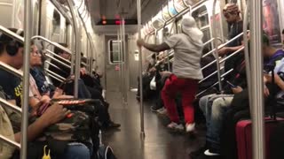 Man in red pants dances on subway train