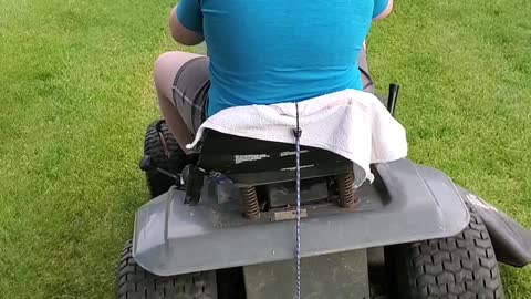 Boy rides lawnmower for the first time
