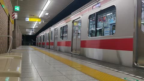 Tokyo Subway Train Pulls Into Shin-Sakuradai Station (bench view)