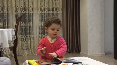 Baby girl adorably reads favorite fairy tale to parents