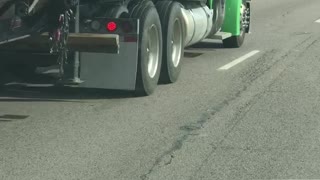 Semi Pushes Car Along Highway