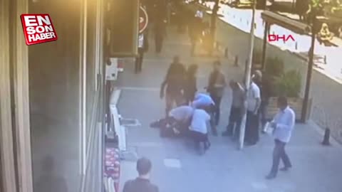 Hero spots a man beating his ex-wife, races down street and knocks him to the ground