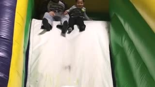 Collab copyright protection - boy falls green inflatable slide