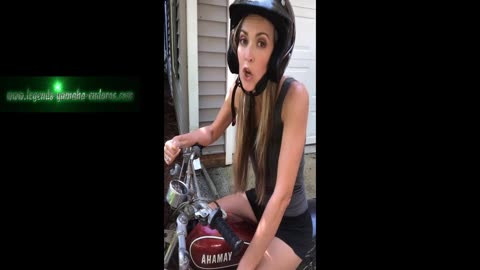 A woman on a 1974 Yamaha GT80A, performs a comedy skit.