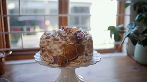 A Cake With Decorations Over A Cake Stand