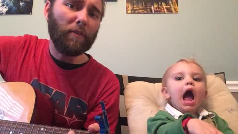 Baby hilariously sings along to dad's guitar-playing