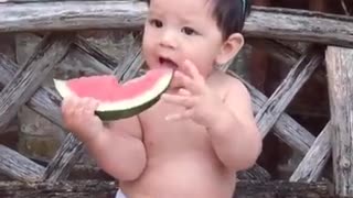 Baby eating watermelon strange style