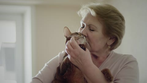 Old woman hugging her cat