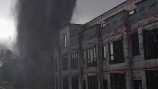 Tornado caught on camera close to the building, fake or real ?