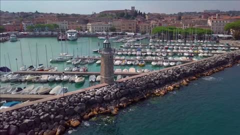 aerial view of boats and lighthouse in lake garda italy