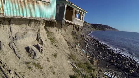 One lasst look at a house being swallowed by the sea