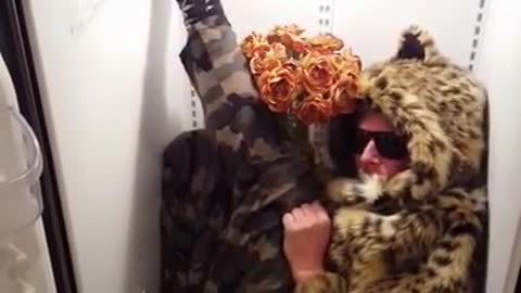 Guy in leopard fur sweater inside fridge