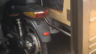 Man takes his motorcycle bike into a crowded subway train