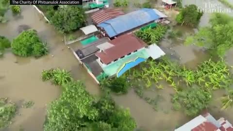 Thai paramotorists fly over flooded areas to drop off essential supplies