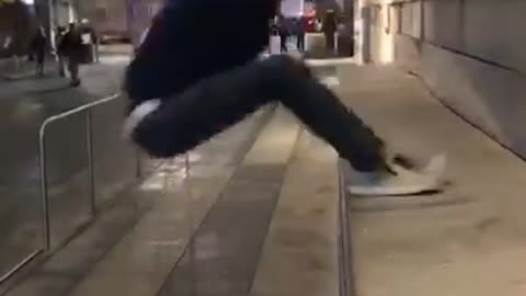 Guy in black jumps on concrete falls back