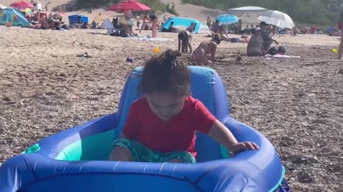 Kid with rubber rafts in beach