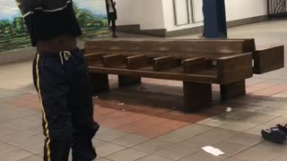 Guy does drag dance in subway station, wig flies off