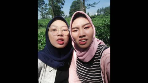With sister in tea garden