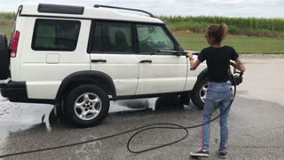 Cute Girl Power Washing Land Rover