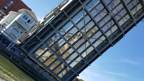 Drawbridge over Mystic River rises up for passing vessels.